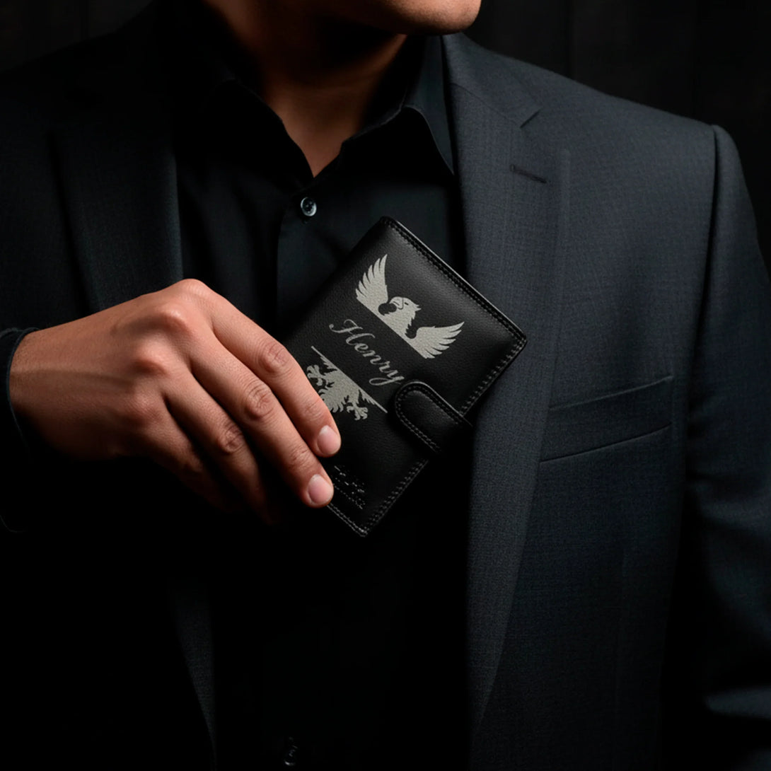 Personalized black leather wallet with name Henry held by a man in a dark suit, men's gift